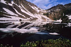 On a quiet morning, ice and snow linger late at Upper Clear Lake.