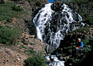 A hiker rests at Lower Twin Falls, Yankee Boy Basin.