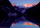Morning light mirrors Mounts Lefroy Victoria in Lake Louise, Banff National Park.