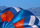 An inflating balloon provides a colorful foreground.