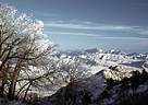 Snow scene from high ridges of the Organ Mountains, with the tip of Sugarloaf Peak visible